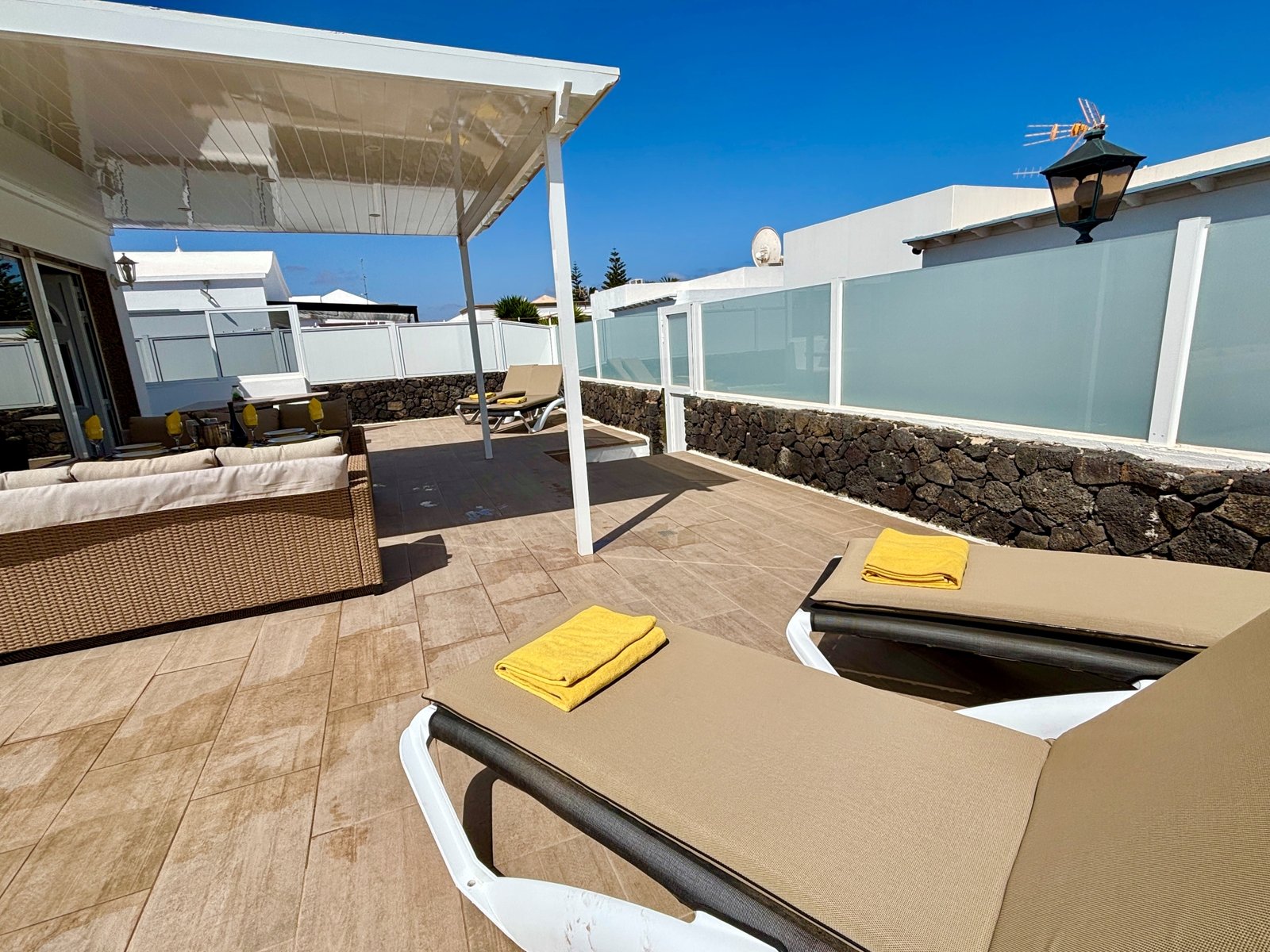 a deck with chairs and a white roof